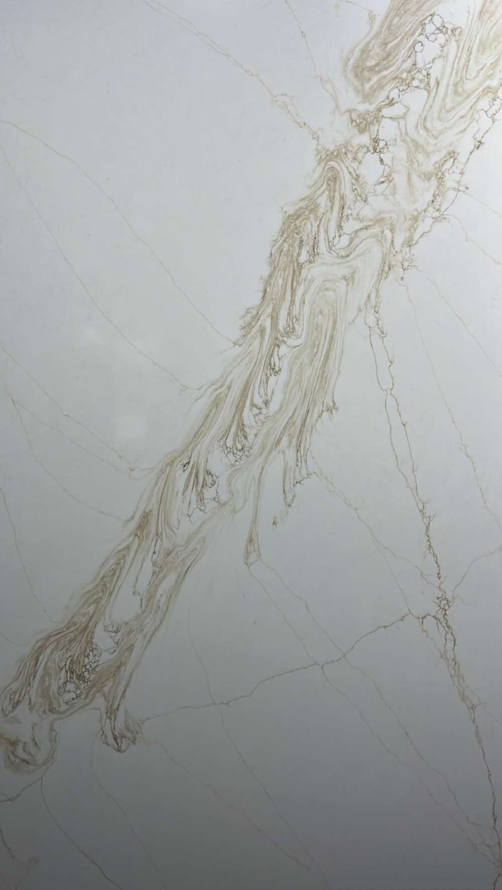 White quartz slab with a single sweep of gold-brown veining