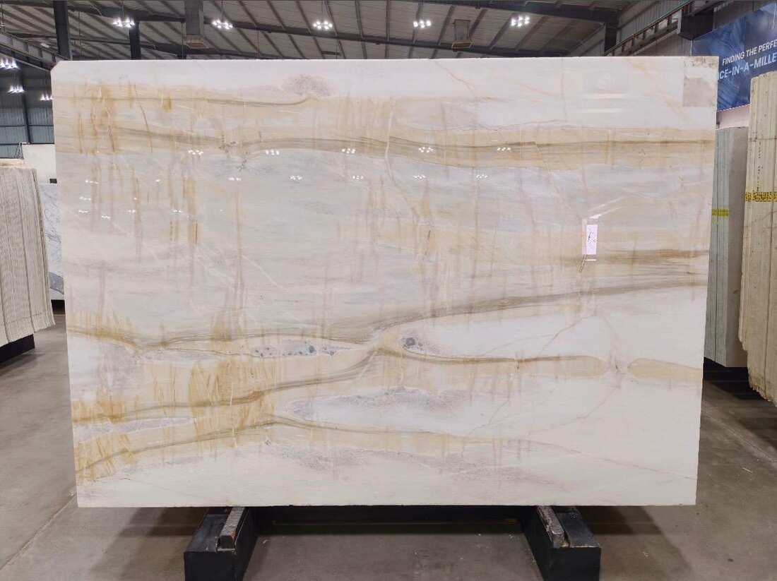 Cream marble with gold-brown veining running the width of the slab